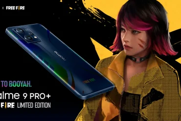 Smartphone realme 9 Pro+ Free Fire Limited Edition flotando sobre fondo oscuro, acompañado por un personaje femenino del videojuego con cabello rosa y chaqueta amarilla. Imagen promocional con estética gamer y estilo gráfico llamativo.